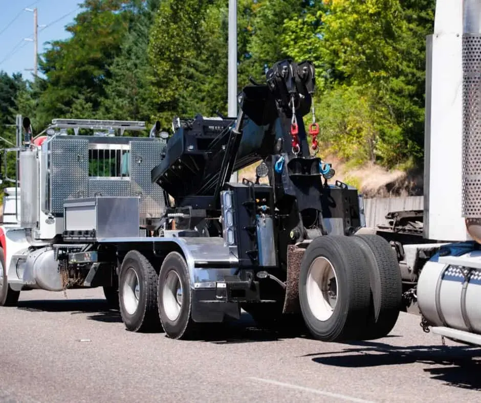 heavy-duty wrecker on a Stonewall highway shoulder