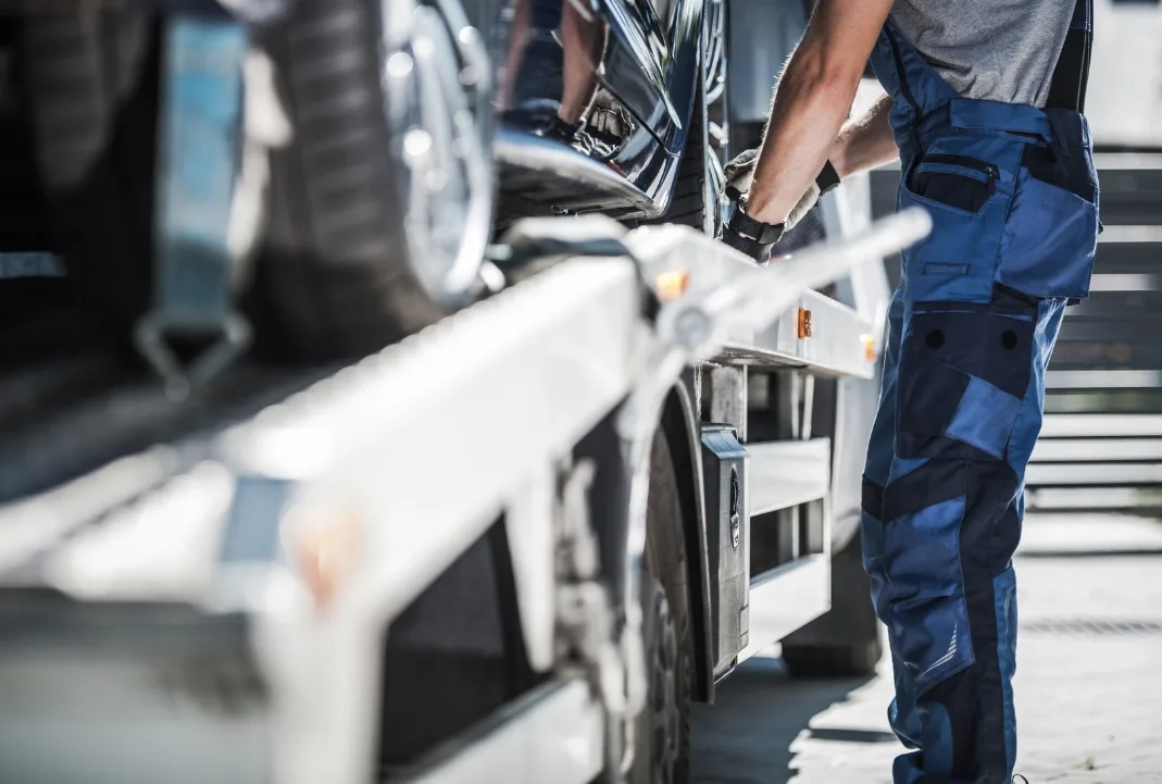 Winnipeg tow truck driver loading a car onto a flatbed